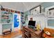 Home office with built-in shelves, a desk, and access to the bathroom at 2886 Bay Shore Dr, Safety Harbor, FL 34695