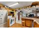 Kitchen with white appliances, wood cabinets, and a kitchen island with seating at 2886 Bay Shore Dr, Safety Harbor, FL 34695