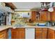 Kitchen with wood cabinets, a double sink, and a dishwasher at 2886 Bay Shore Dr, Safety Harbor, FL 34695