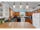 Bright kitchen with wood cabinets, green countertops, and an island at 2886 Bay Shore Dr, Safety Harbor, FL 34695