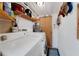 Small laundry room with washer, dryer, and storage shelves at 2886 Bay Shore Dr, Safety Harbor, FL 34695