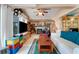 Living room with white couch, fireplace, and a large TV at 2886 Bay Shore Dr, Safety Harbor, FL 34695