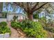 Landscaped side yard with brick path and lush greenery at 2886 Bay Shore Dr, Safety Harbor, FL 34695