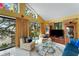Sunroom with water views, comfy seating, and a large TV at 2886 Bay Shore Dr, Safety Harbor, FL 34695