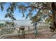Peaceful waterfront view with white fence and yard decor at 2886 Bay Shore Dr, Safety Harbor, FL 34695