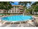 Relaxing circular pool with surrounding lounge chairs at 3035 Countryside Blvd # 31B, Clearwater, FL 33761