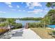 Spacious backyard with a waterfront view, dock, and patio area at 3098 Phoenix Ave, Oldsmar, FL 34677