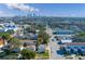 Aerial view of a house and its surroundings, showing city skyline in the distance at 312 S Arrawana Ave, Tampa, FL 33609
