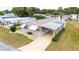 Attractive manufactured home with carport and surrounding homes visible at 36900 Grace Ave, Zephyrhills, FL 33542