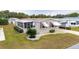 Mobile home with screened porch, landscaping, and paved driveway at 36900 Grace Ave, Zephyrhills, FL 33542