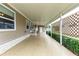 Long covered patio with lattice and greenery at 36900 Grace Ave, Zephyrhills, FL 33542
