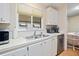 Clean kitchen with white cabinets and stainless steel appliances at 36900 Grace Ave, Zephyrhills, FL 33542