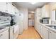 Efficient kitchen with white cabinets and appliances at 36900 Grace Ave, Zephyrhills, FL 33542