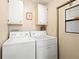 Laundry room with washer, dryer, and cabinets at 36900 Grace Ave, Zephyrhills, FL 33542