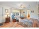 Living room features hardwood floors, ceiling fan and a relaxing sitting area at 36900 Grace Ave, Zephyrhills, FL 33542