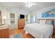 Main bedroom with wood floors, a dresser, and a large bed at 36900 Grace Ave, Zephyrhills, FL 33542