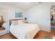 Main bedroom with wood floors, large windows, and a queen bed at 36900 Grace Ave, Zephyrhills, FL 33542