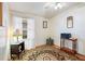 Bright home office features a stained glass lamp, window coverings and area rug at 36900 Grace Ave, Zephyrhills, FL 33542