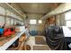 Workshop with shelves, workbench and covered grill at 36900 Grace Ave, Zephyrhills, FL 33542