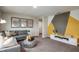 Gathering room with gray sectional sofa and accent wall at 37268 Sagemoor Dr, Zephyrhills, FL 33541