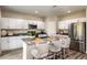 Modern kitchen with white cabinets, stainless steel appliances, and an island at 37268 Sagemoor Dr, Zephyrhills, FL 33541