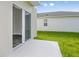 Sliding glass door opens to a small patio and grassy backyard at 37306 Sagemoor Dr, Zephyrhills, FL 33541