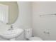 Clean bathroom with pedestal sink, toilet and oval mirror at 37306 Sagemoor Dr, Zephyrhills, FL 33541