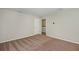 Bright bedroom with neutral walls and carpeting, laundry access at 37306 Sagemoor Dr, Zephyrhills, FL 33541