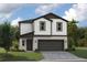 Two-story house with dark brown accents and a two-car garage at 37306 Sagemoor Dr, Zephyrhills, FL 33541