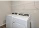 Laundry room with Whirlpool washer and dryer at 37306 Sagemoor Dr, Zephyrhills, FL 33541