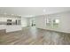 Spacious living area with wood-look floors and access to backyard at 37306 Sagemoor Dr, Zephyrhills, FL 33541