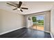 Bright bedroom with dark hardwood floors and sliding doors to deck at 4318 Spinnaker Cove Ln, Tampa, FL 33615