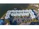 Aerial view of the building, parking lot, and waterfront location at 464 N Paula Dr # 220, Dunedin, FL 34698