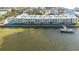 Aerial view of waterfront community with condos and a private dock at 464 N Paula Dr # 220, Dunedin, FL 34698