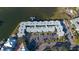Aerial view of condo building with parking and waterfront access at 464 N Paula Dr # 220, Dunedin, FL 34698