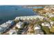 Aerial view of waterfront community with various buildings and parking at 464 N Paula Dr # 220, Dunedin, FL 34698