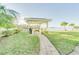 Relaxing waterfront patio area with brick pathway and lush landscaping at 464 N Paula Dr # 220, Dunedin, FL 34698