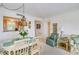 Bright dining area features a chandelier and kitchen view at 464 N Paula Dr # 220, Dunedin, FL 34698