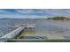 Private wooden dock extends over calm water, offering scenic waterfront views at 464 N Paula Dr # 220, Dunedin, FL 34698