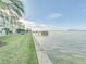 Waterfront property with a lush lawn leading to the water at 464 N Paula Dr # 220, Dunedin, FL 34698