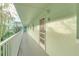 Building hallway with light green walls and white railings at 464 N Paula Dr # 220, Dunedin, FL 34698