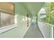 Building hallway with light green walls and white railings at 464 N Paula Dr # 220, Dunedin, FL 34698