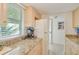 Kitchen features granite countertops, light wood cabinets, and a window at 464 N Paula Dr # 220, Dunedin, FL 34698