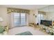 Living room features water views and sliding glass doors to balcony at 464 N Paula Dr # 220, Dunedin, FL 34698
