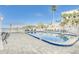 Inviting community pool with patio furniture and waterfront views at 464 N Paula Dr # 220, Dunedin, FL 34698