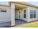 Inviting front entry with a tiled porch and decorative columns at 4846 Sandy Glen Way, Wimauma, FL 33598