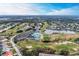 Aerial view showcasing clubhouse, golf course, and lake at 6303 Green Oak Cir, Bradenton, FL 34203