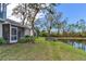 Backyard view of home with pond and lush trees at 6303 Green Oak Cir, Bradenton, FL 34203