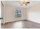 Bright bedroom with wood-look floors, large window, and mirrored closet at 6303 Green Oak Cir, Bradenton, FL 34203
