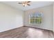 Bright bedroom with wood-look floors and a large window with a view at 6303 Green Oak Cir, Bradenton, FL 34203